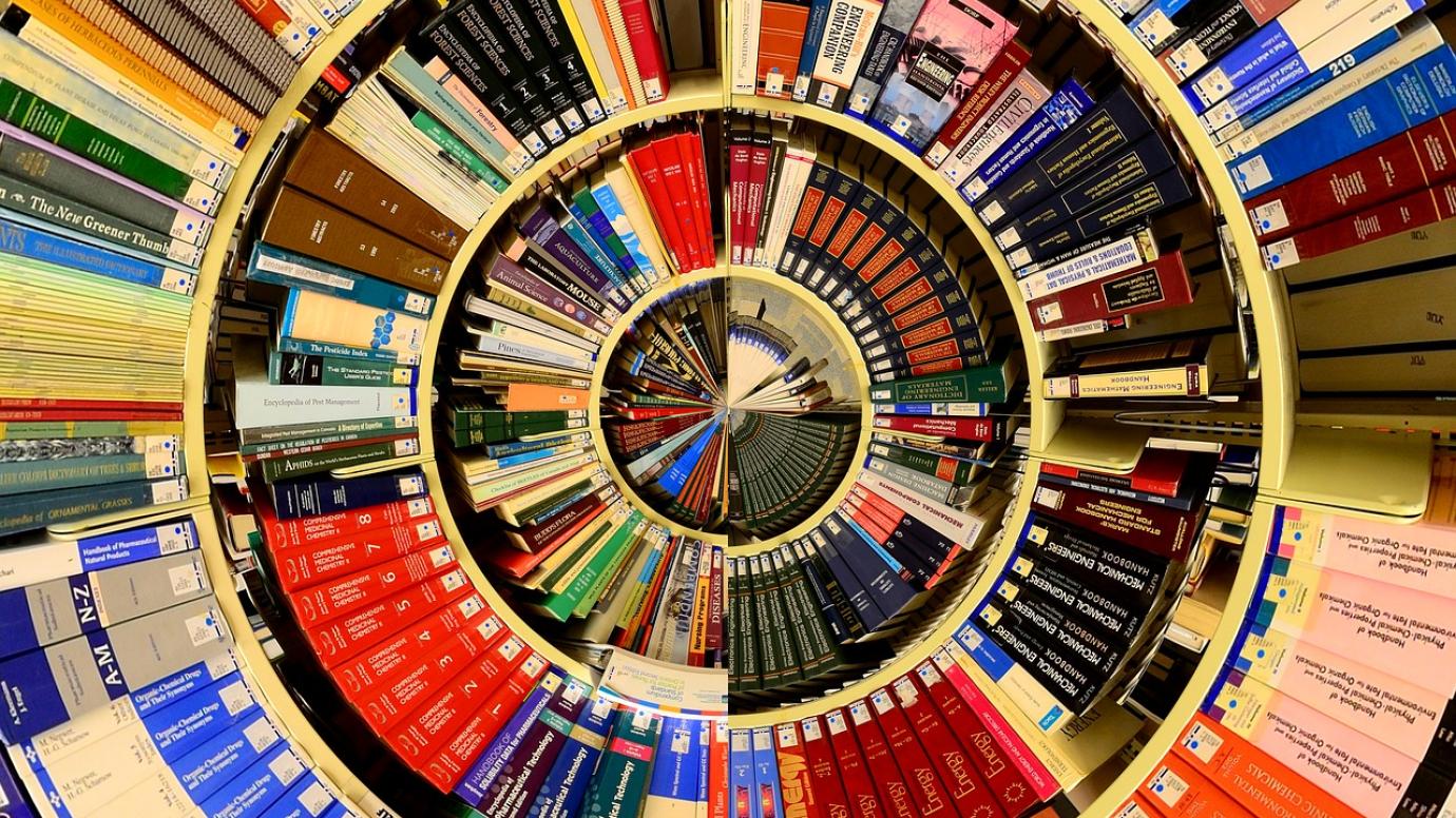 University books arranged on a spiral-shaped set of shelves